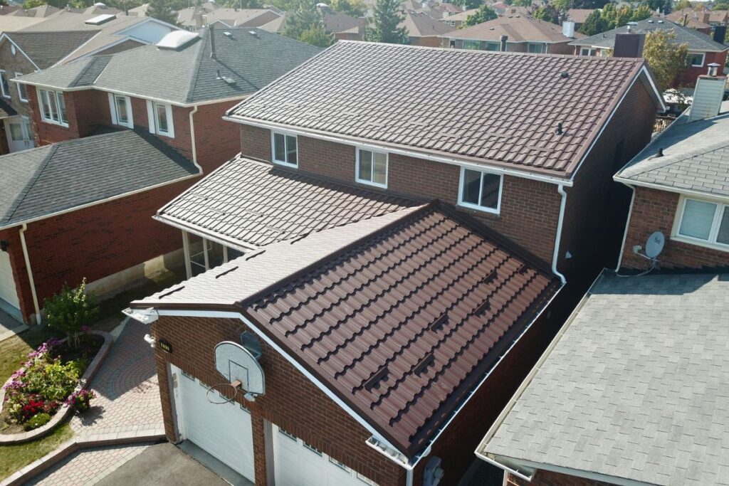 Residential roof with newly installed metal tiles, featuring a clean and sleek design.