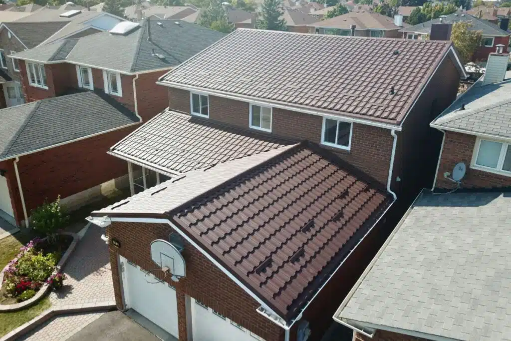 Residential roof with newly installed metal tiles, featuring a clean and sleek design.