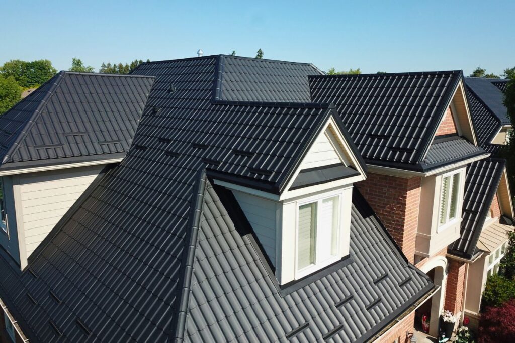 Newly installed metal roof with sleek black tiles, offering durability and an attractive finish, transforming the home's appearance.