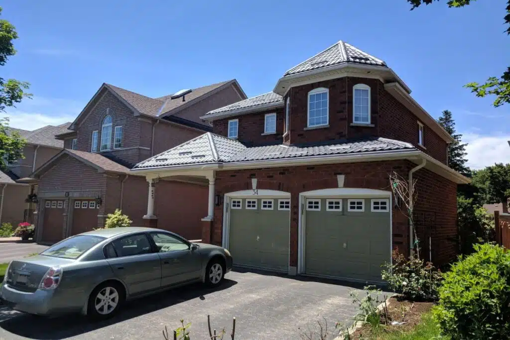 A close-up of a charming home with a contemporary gray metal roof, blending seamlessly with the brick exterior and modern details.