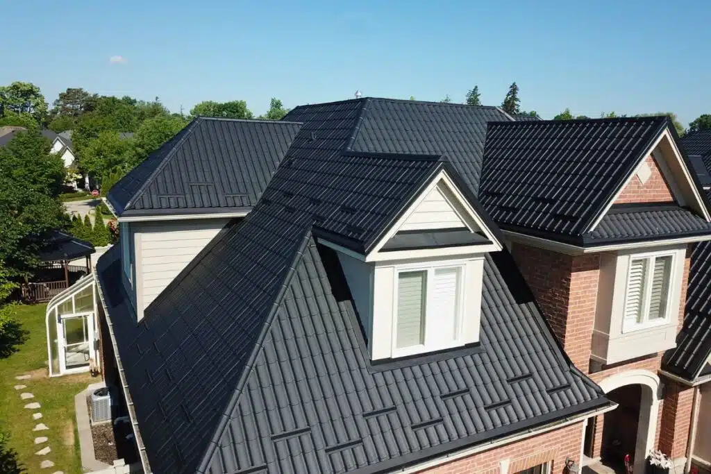 The completed roof with sleek black metal tiles on a home in Canyon, North York, replacing the original shingle roof.