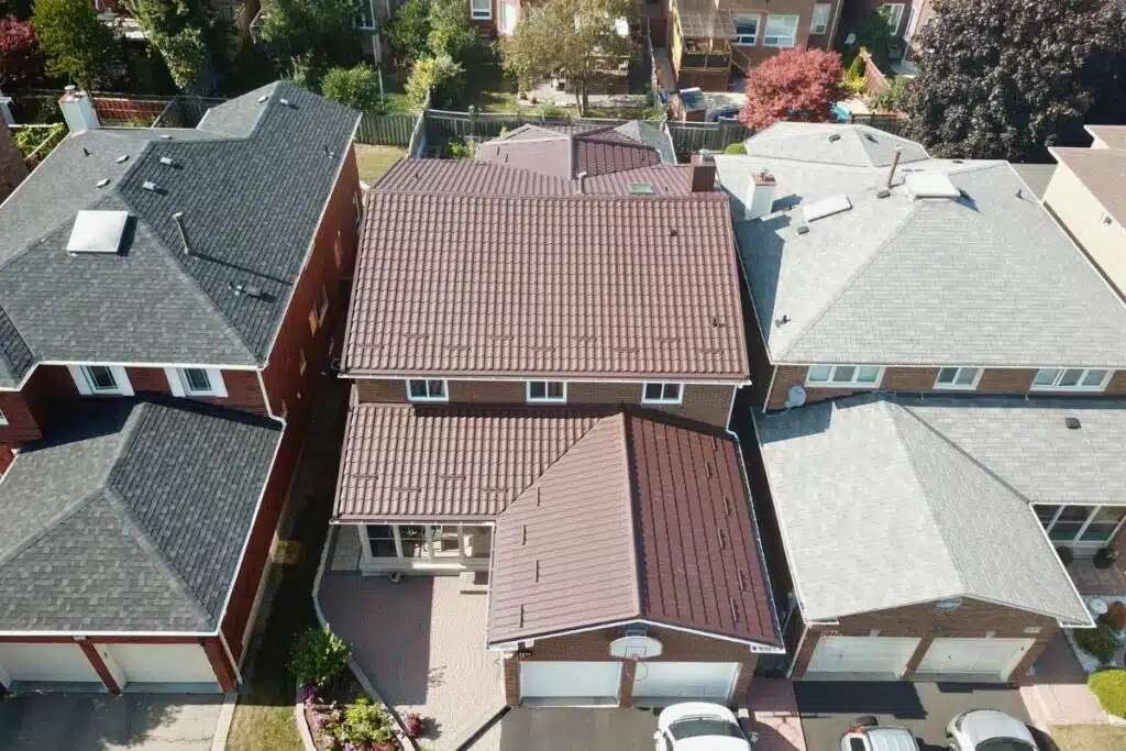 Sleek brown metal roof with a distinct ridge, contrasting with neighboring homes and offering modern appeal.