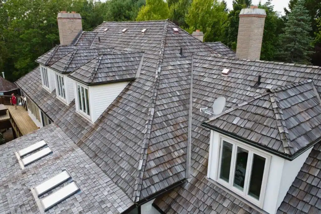 Weathered Cedar Shingle Roof with Skylights Before Replacement Old cedar roof with weathered shingles and skylights.