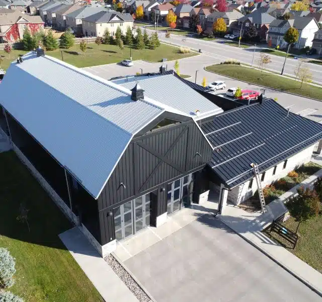 Modern commercial building with black and white metal roofing.