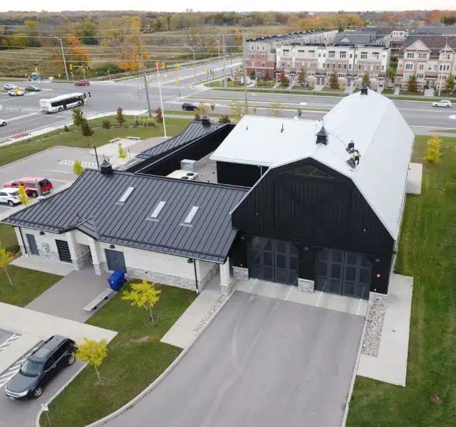 Modern commercial building with black and white metal roofing system.