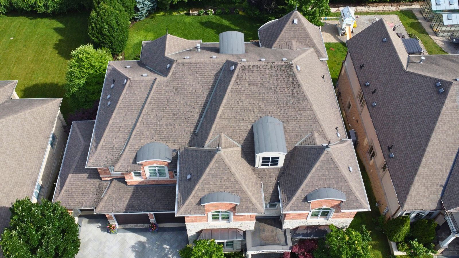 Existing asphalt shingle roof before metal tile installation on a residential project