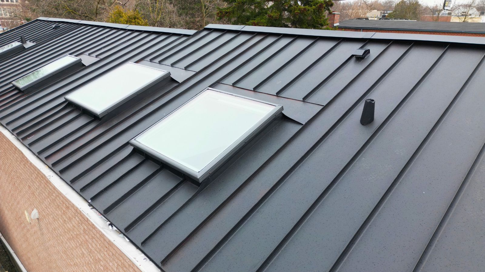 Four VELUX skylights integrated into a standing seam metal roof