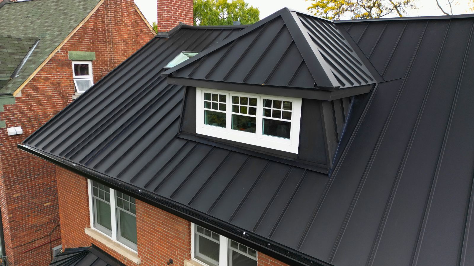 Front Dormer Standing Seam Roof Detail Midnight Black standing seam roof with a matching metal-clad dormer on a century home in High Park