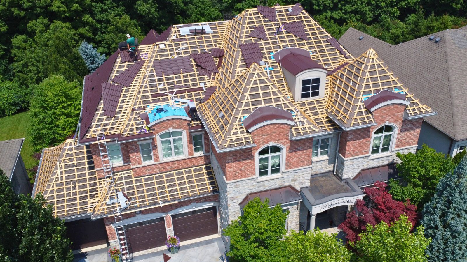 Wood strapping and metal tile panel installation over existing asphalt shingles
