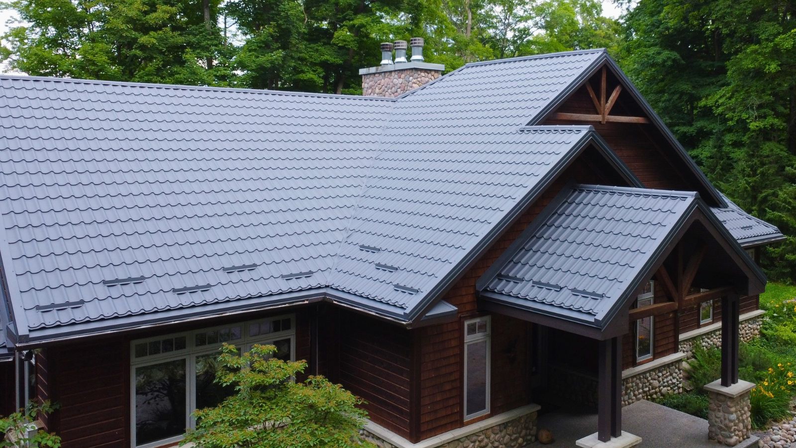 Multi-slope Ruukki Monterrey metal tile roof with hips, valleys, and front roof sections