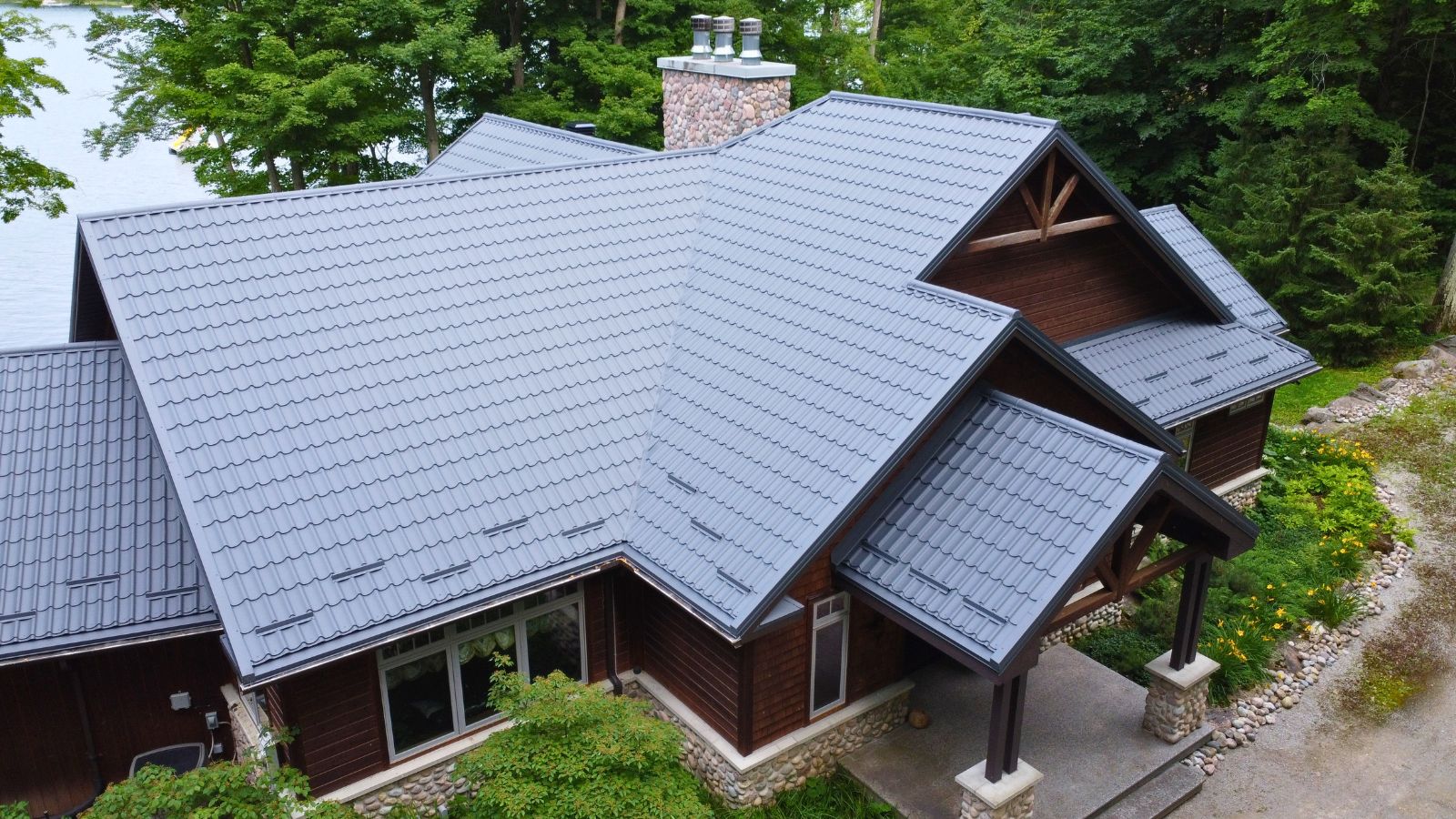 RR22 Grey Ruukki Monterrey metal tile roof with multiple roof slopes, hips, valleys, and individual snow guards