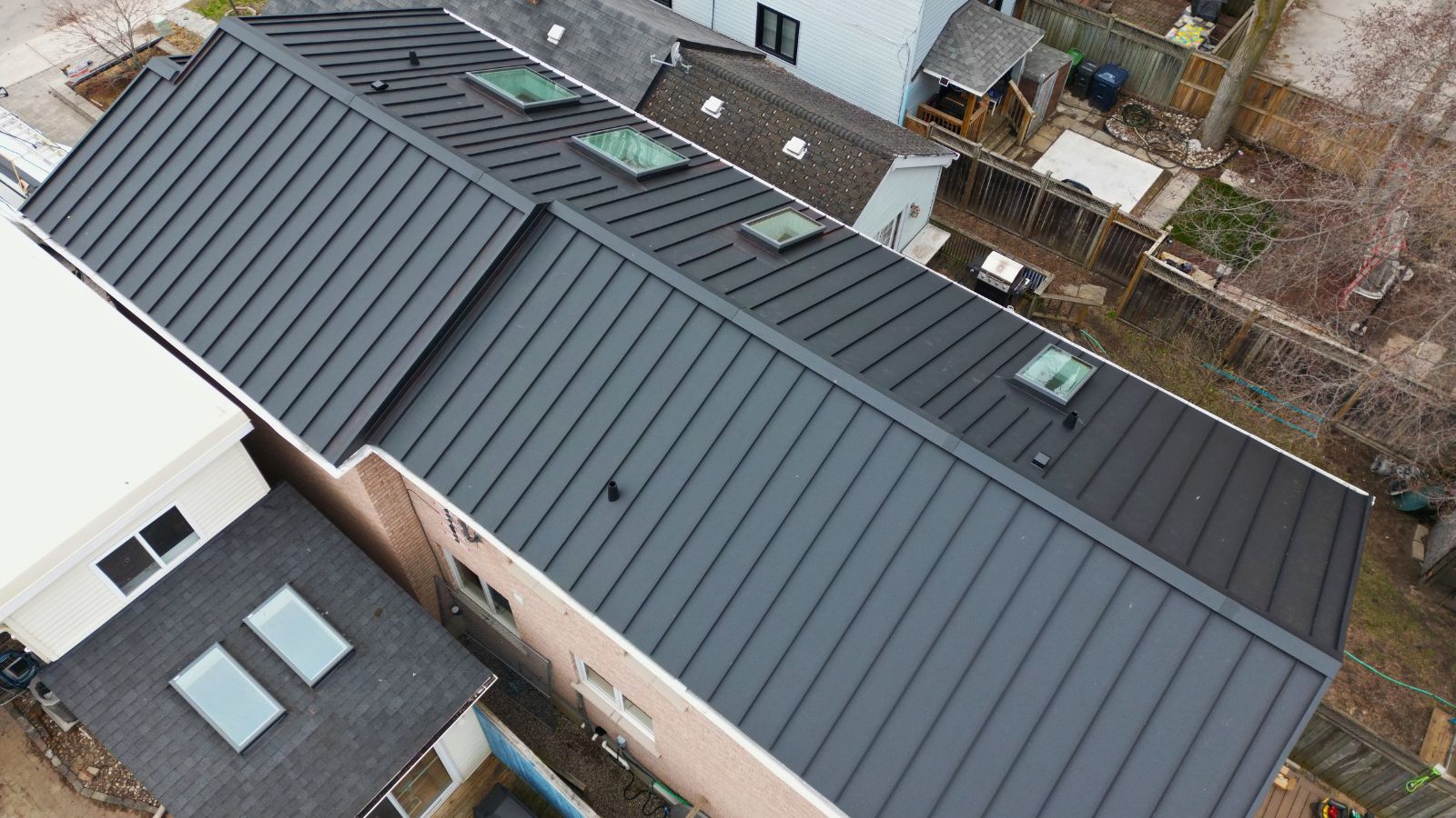 Aerial view of a standing seam metal roof with four VELUX skylights in Woodbine-Lumsden