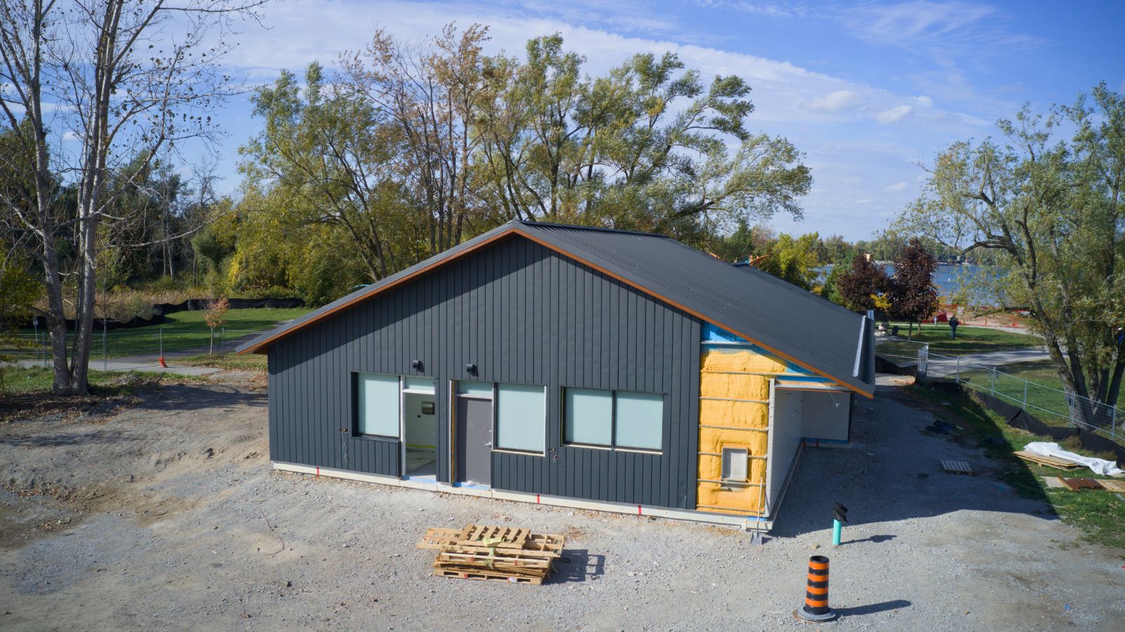 Standing Seam Metal Roof in Innisfil Park Textured Black Matt standing seam metal roof with matching vertical wall panels on a cottage-style building in Innisfil Park