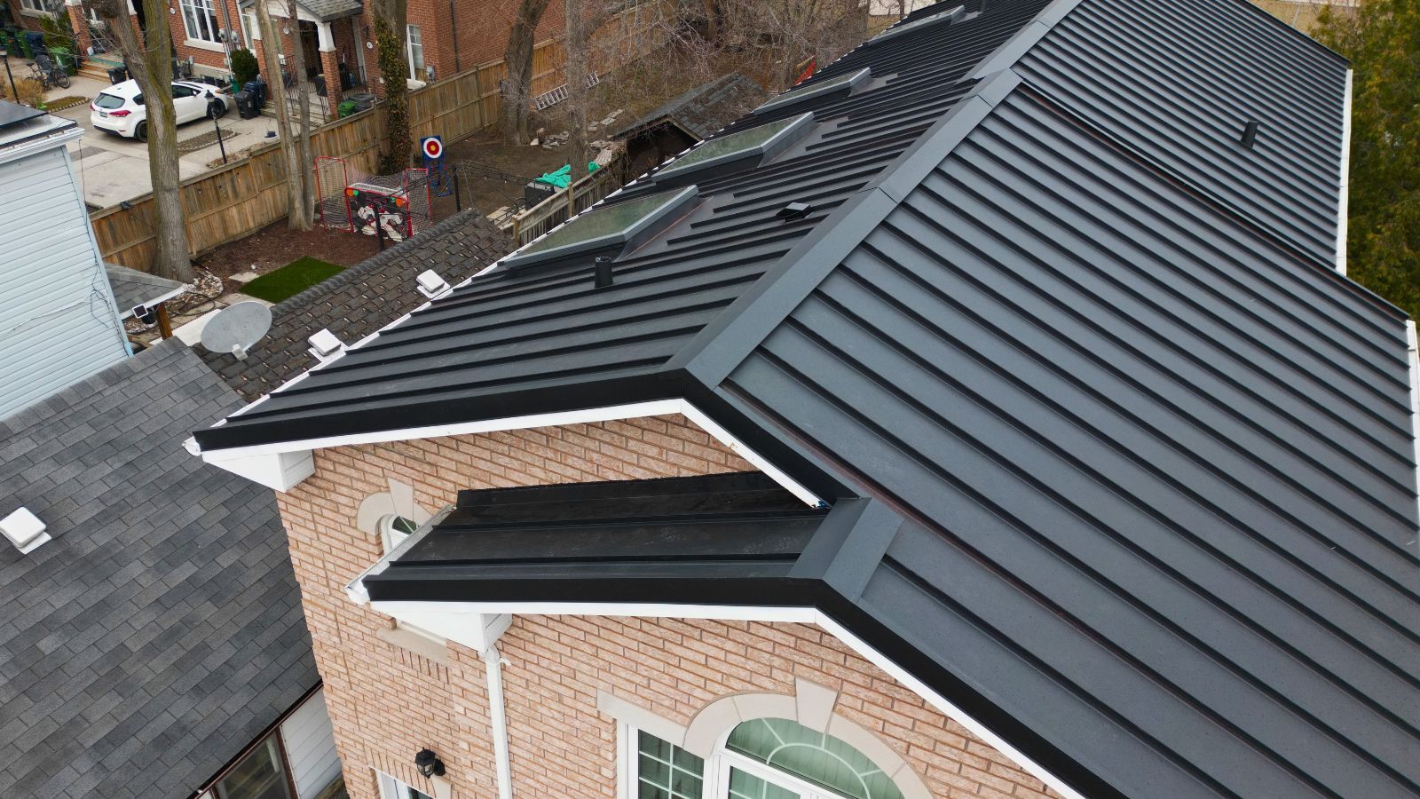 Standing seam metal panels across the intersecting roof sections