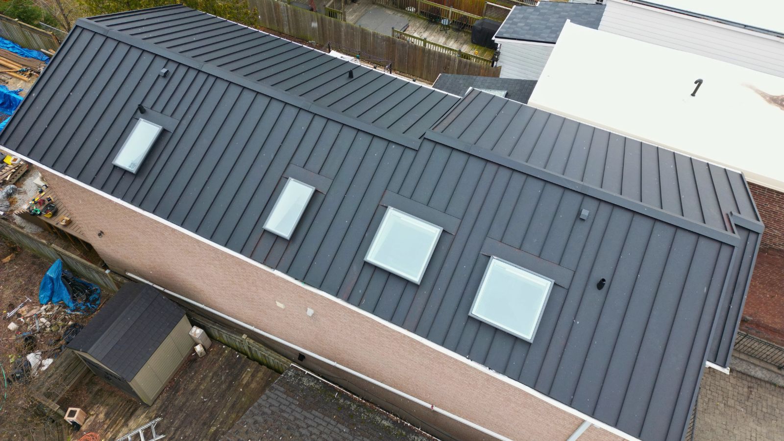 Textured Black Matt standing seam roof installed on a Woodbine-Lumsden home