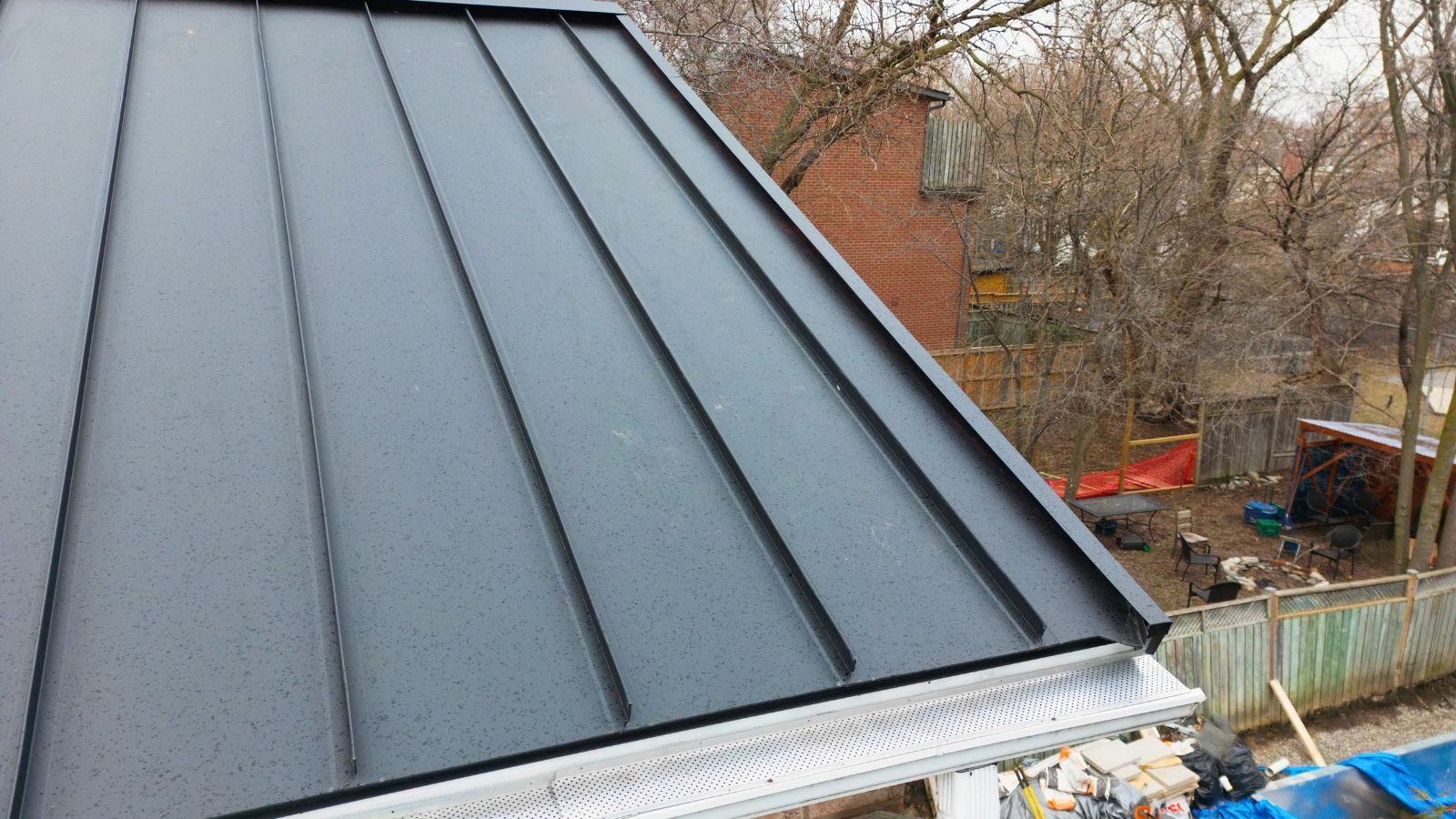 Textured Black Matt standing seam panels with matching roof edge trim