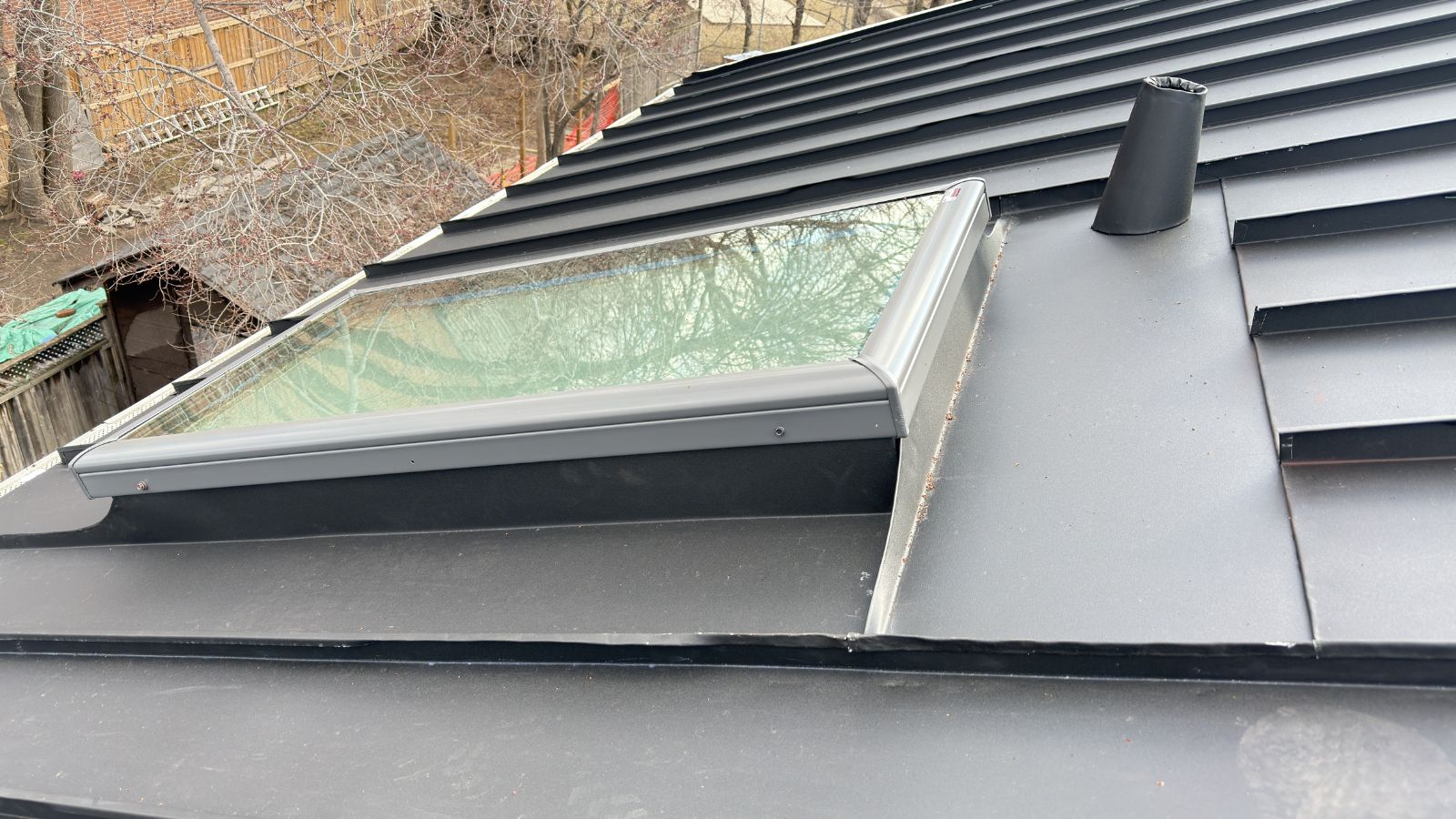 Close view of VELUX skylight flashing on a standing seam metal roof